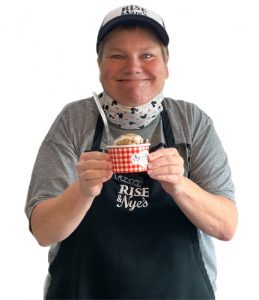 Rise & Nye's team member with special needs holding a dish of scooped ice cream.